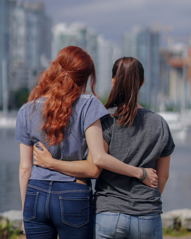 Redhead and Brunette looking out at Vancouver skyline