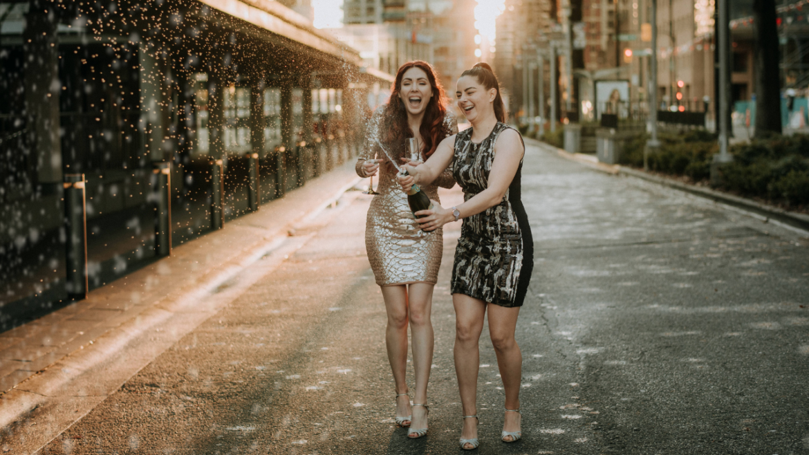 Lesbian Couple Champagne Spray Celebration